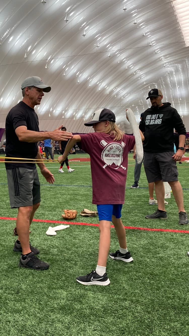 Coach working with young athlete on form
