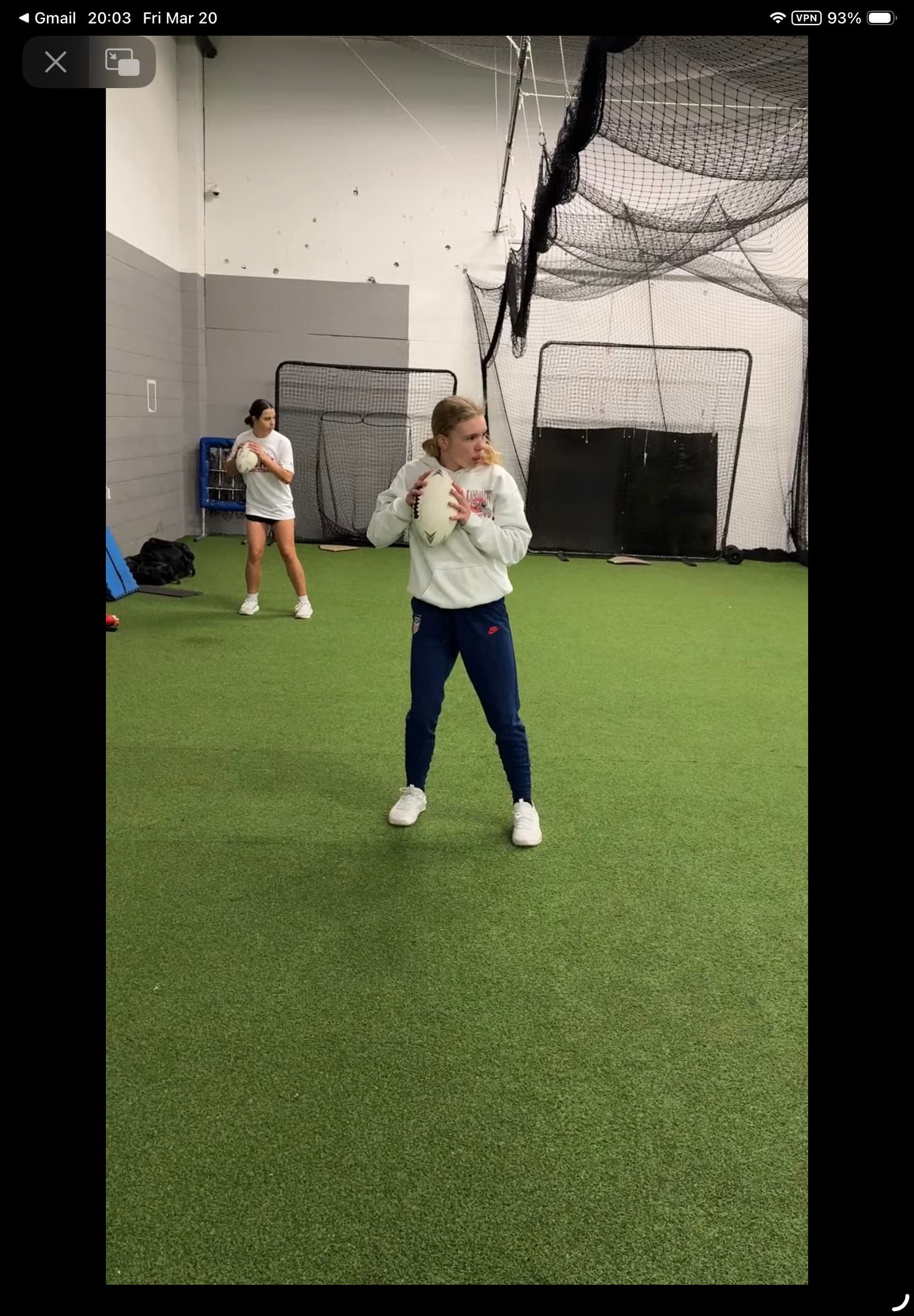 Female athlete training with football