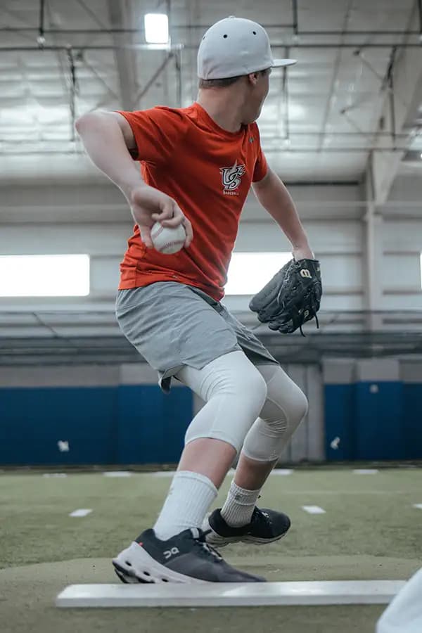 Youth pitcher mid-delivery